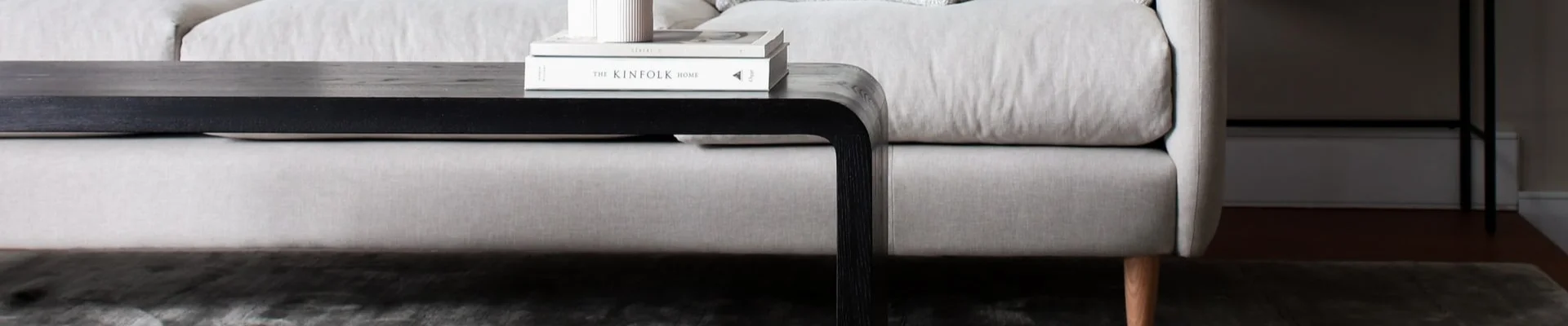 Stylish home with a light sofa and grey area rug